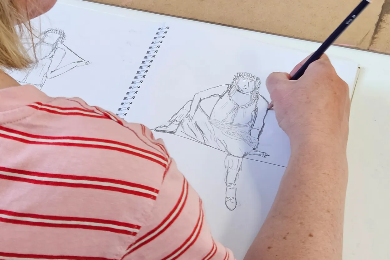 A female participant takes part in a life drawing class