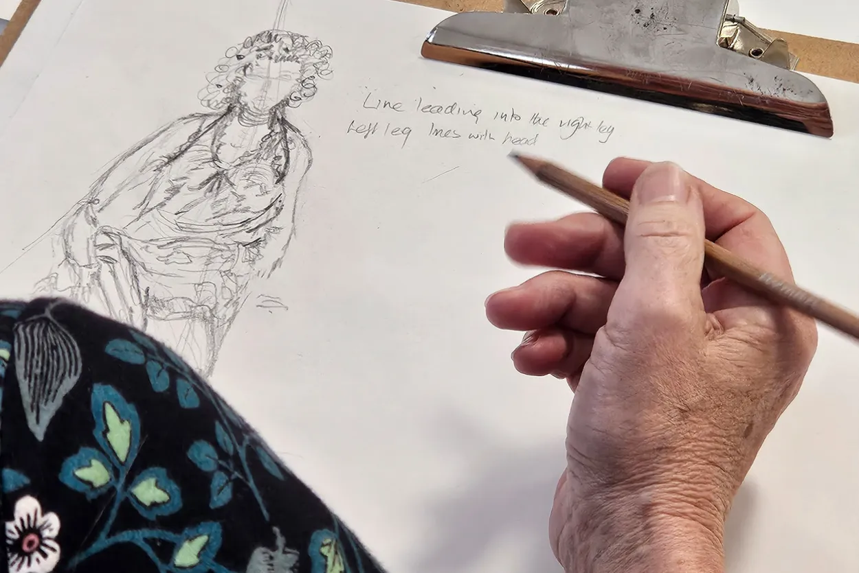 A woman takes part in a life drawing class