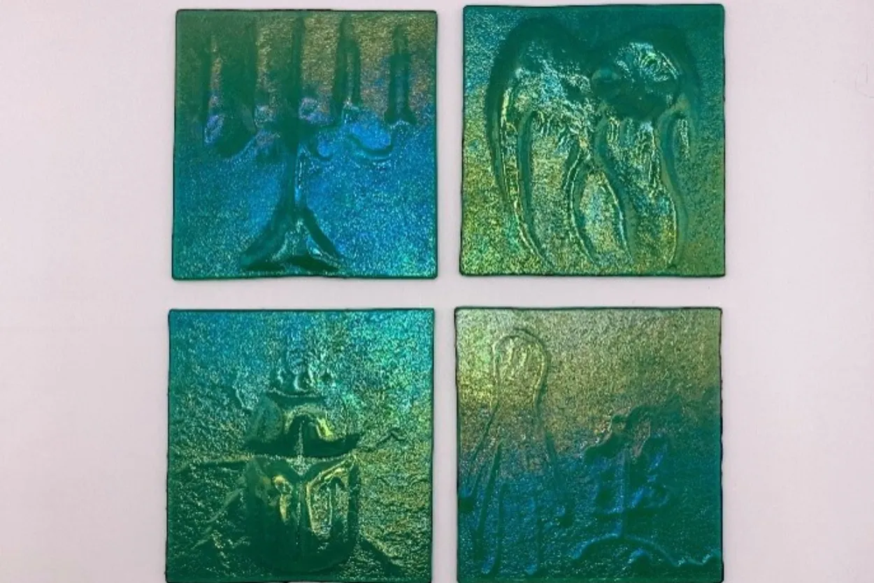 Photograph of four hand made tiles