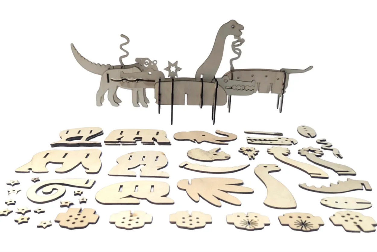 Wooden dinosaurs body parts laid on a table