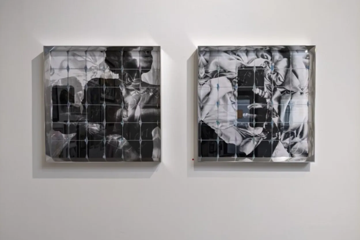 Two large black and white square prints portraying the artist taking a selfie