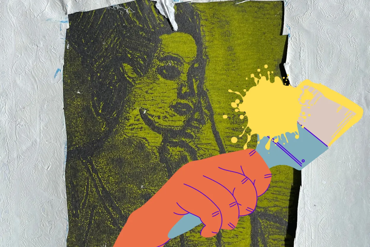 An image of a green monoprint portrait mounted with a white painted frame. Overlayed is an orange hand holding a paintbrush splashing yellow paint.