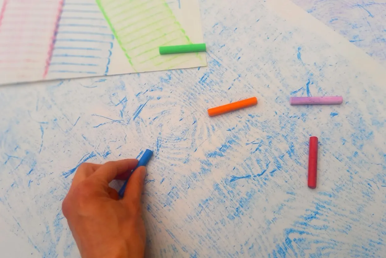 A close-up of colourful rubbings made using crayons on paper