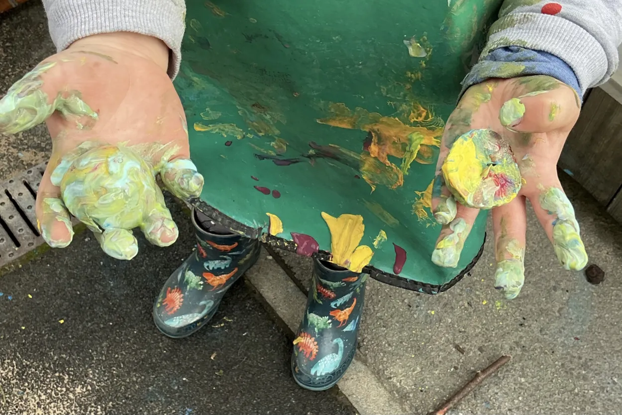 Child holding painted crab apple