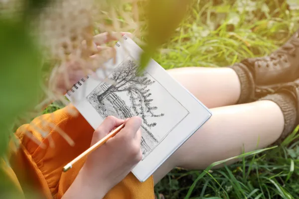 Person drawing a tree
