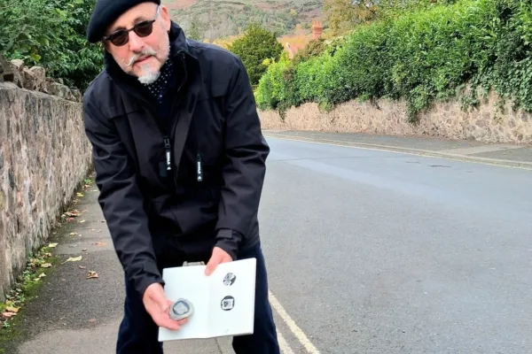 A man drawing in the street