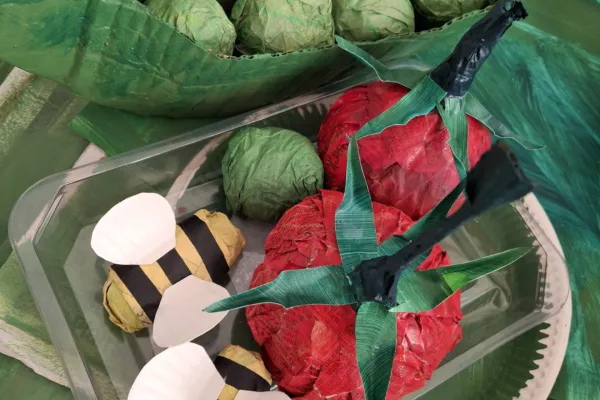 Photograph of hand made paper vegetables and insects