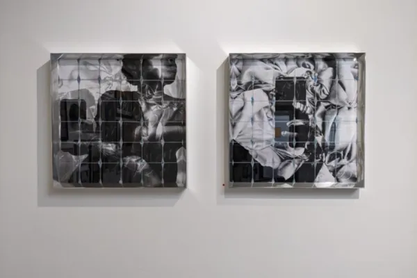 Two large black and white square prints portraying the artist taking a selfie