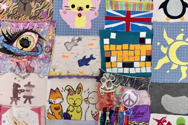 The image shows various colourful quilt squares, some painted, some sewn into, some with heat press vinyl decoration