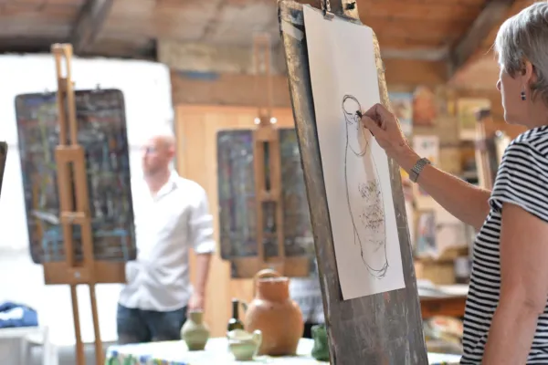 People drawing on easels